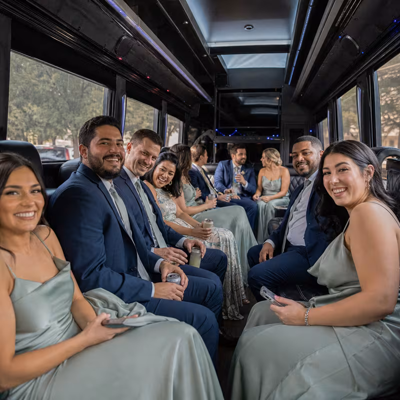 Wedding guests seated inside a Plano party bus