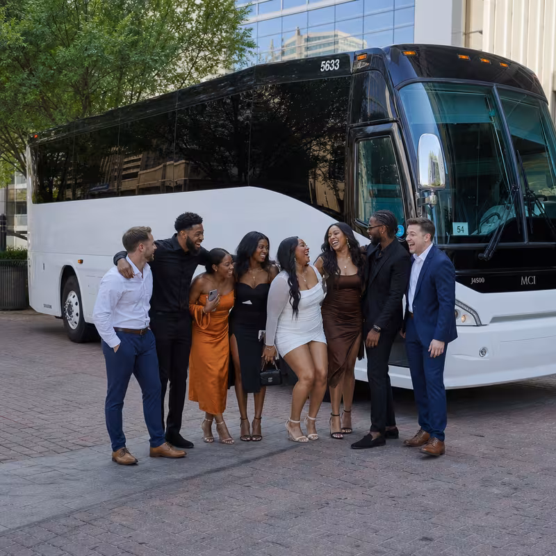 Passengers loading luggage while boarding an Plano group shuttle