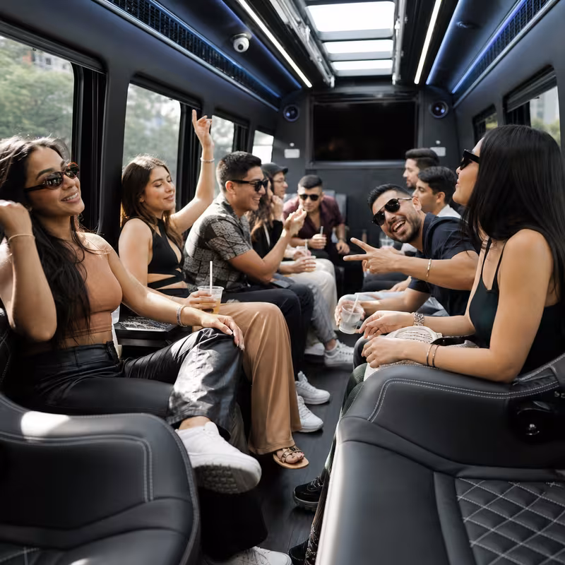 Group boarding a white charter bus for Concert Transportation transportation in Plano
