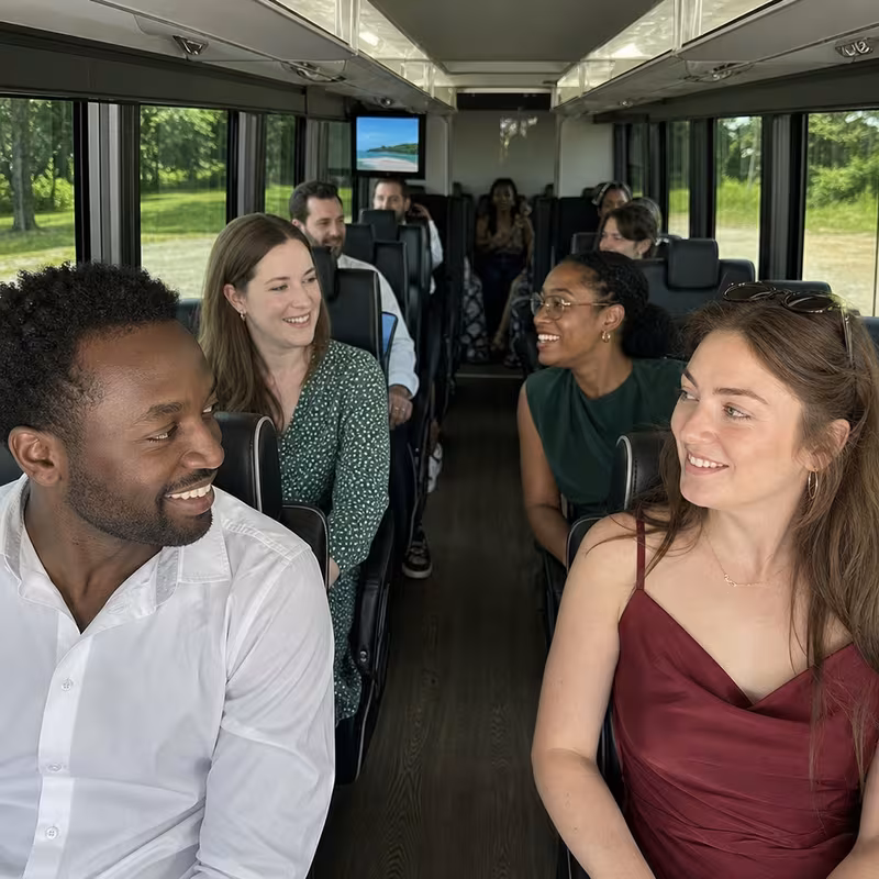 Group boarding a white charter bus for Private Event Transportation transportation in Plano