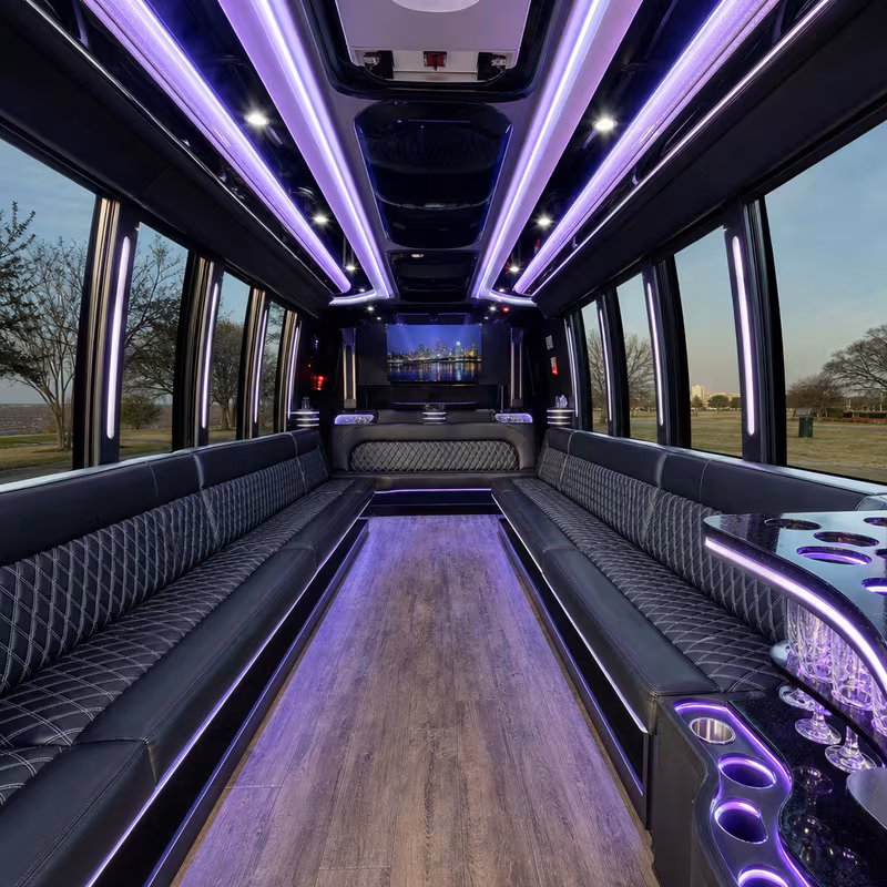 Party bus interior with wraparound leather seating and LED lighting in Plano