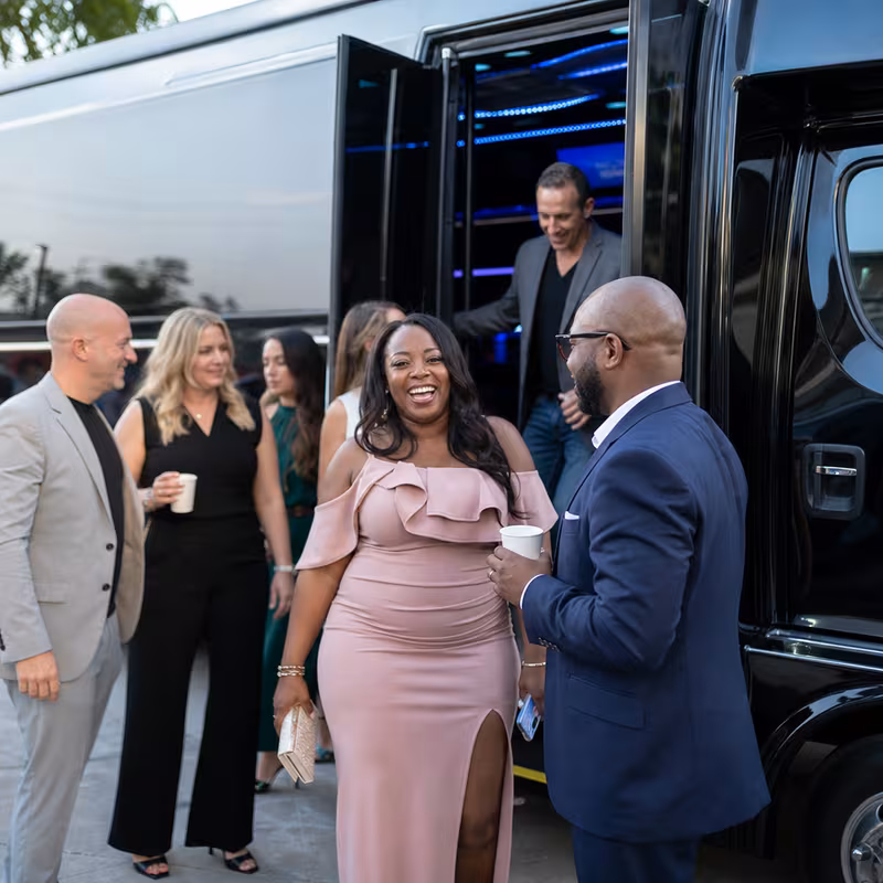 Passengers loading luggage while boarding an Plano group shuttle