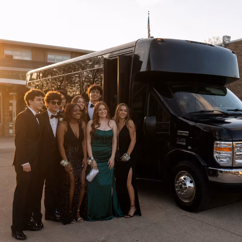 Group boarding a white charter bus for Prom & Homecoming Transportation transportation in Plano