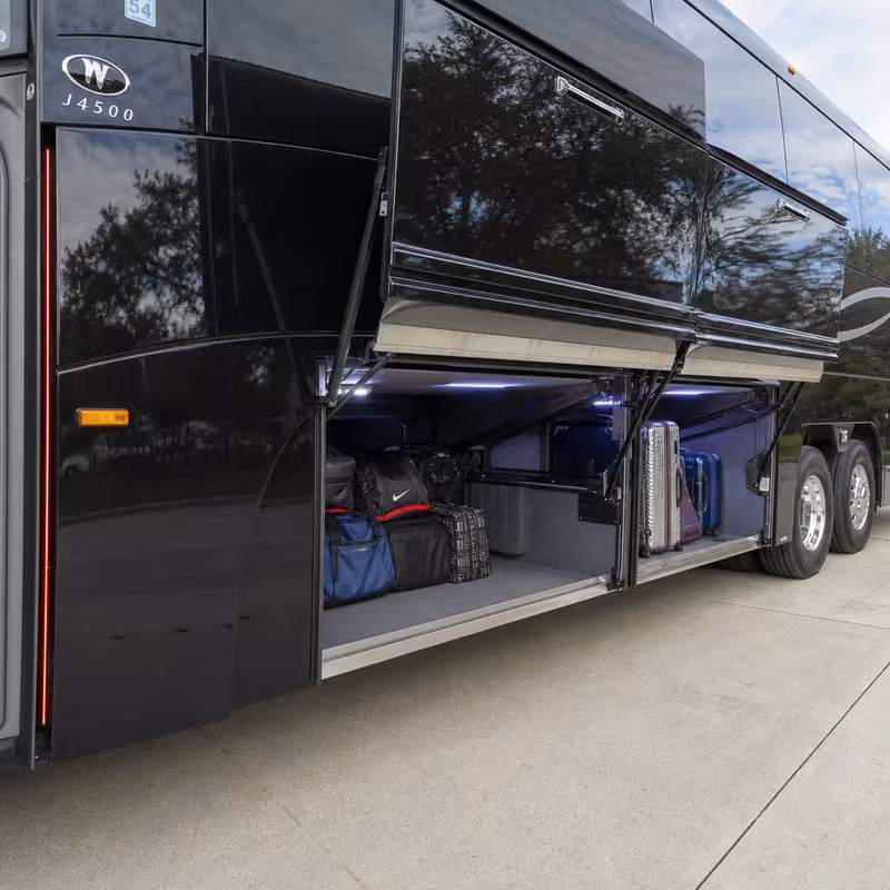 Party bus interior with wraparound leather seating and LED lighting in Plano