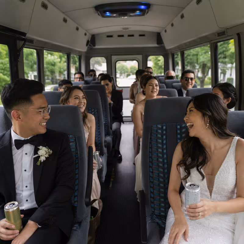 Group boarding a white charter bus for Wedding Transportation transportation in Plano