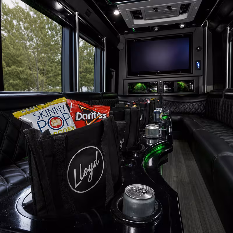 Party bus interior with wraparound leather seating and LED lighting in Plano